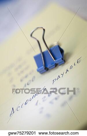 Close-up of a binder clip on a sheet of paper View Large Photo Image Stock Image - Close-up of a binder clip on a sheet of paper. Fotosearch