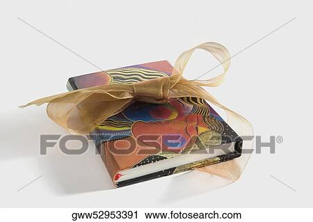 Stock Image - Close-up of a book with a bow tied around it. Fotosearch