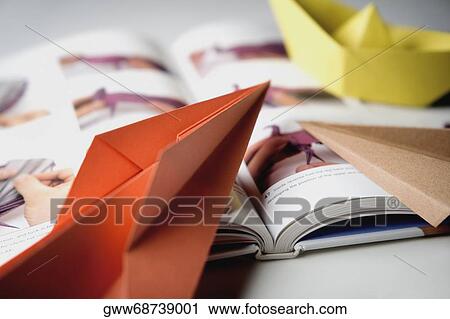 Stock Image - Close-up of a book with paper boats. Fotosearch