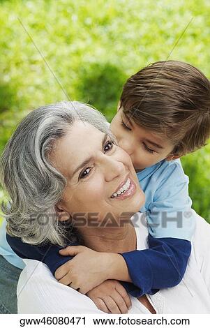Close-up of a boy kissing his grandmother View Large Photo Image Stock Image - Close-up of a boy kissing his grandmother. Fotosearch