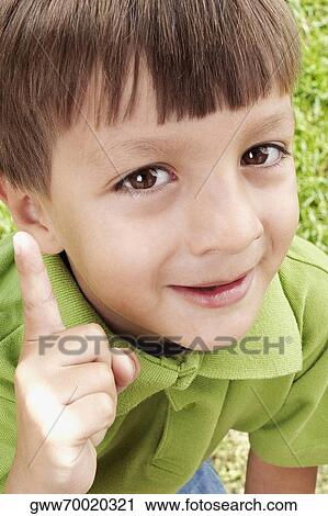 Close-up of a boy pointing and smiling View Large Photo Image Stock Image - Close-up of a boy pointing and smiling. Fotosearch