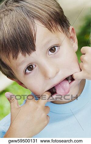 Close-up of a boy stretching his mouth with his fingers View Large Photo Image Stock Image - Close-up of a boy stretching his mouth with his fingers. Fotosearch
