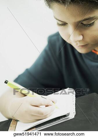 Close-up of a boy writing on a notepad View Large Photo Image Stock Image - Close-up of a boy writing on a notepad. Fotosearch