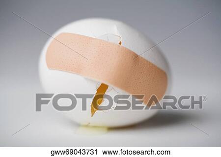 Close-up of a broken egg with an adhesive bandage on it View Large Photo Image Stock Image - Close-up of a broken egg with an adhesive bandage on it. Fotosearch