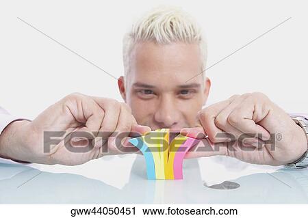 Close-up of a businessman playing with a notepad View Large Photo Image Stock Image - Close-up of a businessman playing with a notepad. Fotosearch