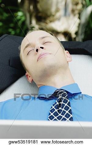 Close-up of a businessman sleeping View Large Photo Image Stock Image - Close-up of a businessman sleeping. Fotosearch