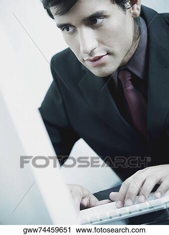 Stock Image - Close-up of a businessman working on a laptop. Fotosearch