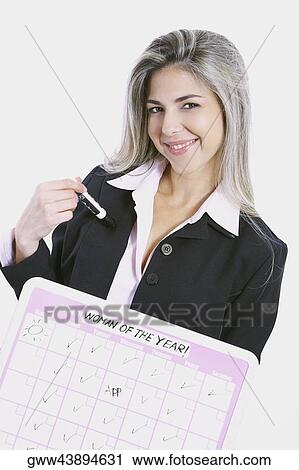 Stock Image - Close-up of a businesswoman holding a progress report and smiling. Fotosearch