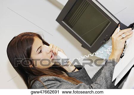 Close-up of a businesswoman talking on the telephone View Large Photo Image Stock Image - Close-up of a businesswoman talking on the telephone. Fotosearch