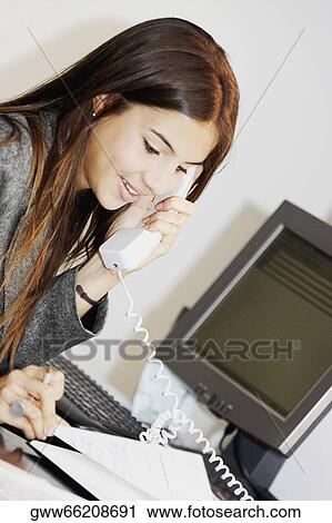 Close-up of a businesswoman talking on the telephone View Large Photo Image Stock Image - Close-up of a businesswoman talking on the telephone. Fotosearch