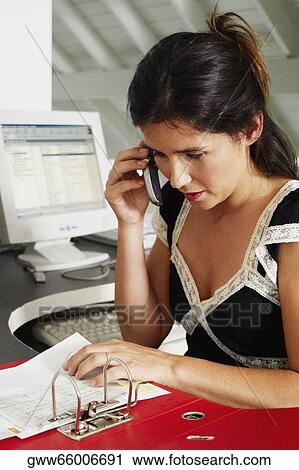 Close-up of a businesswoman using a mobile phone in an office View Large Photo Image Stock Image - Close-up of a businesswoman using a mobile phone in an office. Fotosearch