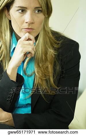 Close-up of a businesswoman with his hand on her chin View Large Photo Image Stock Image - Close-up of a businesswoman with his hand on her chin. Fotosearch