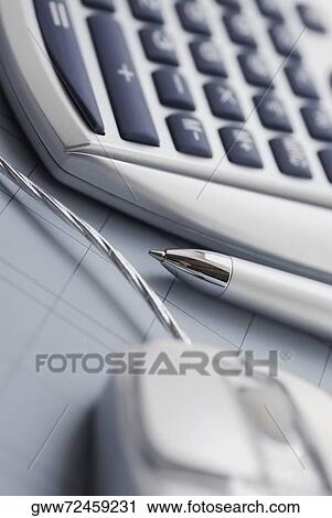 Close-up of a calculator and a computer mouse with a ballpoint pen View Large Photo Image Stock Image - Close-up of a calculator and a computer mouse with a ballpoint pen. Fotosearch