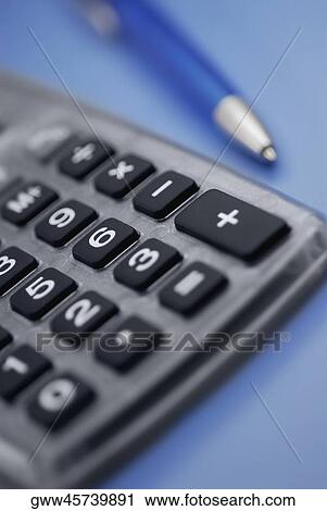 Close-up of a calculator and a pen View Large Photo Image Stock Image - Close-up of a calculator and a pen. Fotosearch