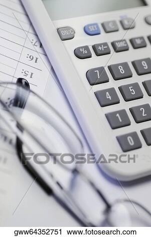 Close-up of a calculator with a pair of eyeglasses on a document View Large Photo Image Stock Image - Close-up of a calculator with a pair of eyeglasses on a document. Fotosearch