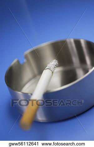 Close-up of a cigarette in an ashtray View Large Photo Image Stock Image - Close-up of a cigarette in an ashtray. Fotosearch