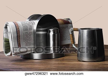 Close-up of a coffee cup with a newspaper on the table View Large Photo Image Stock Image - Close-up of a coffee cup with a newspaper on the table. Fotosearch