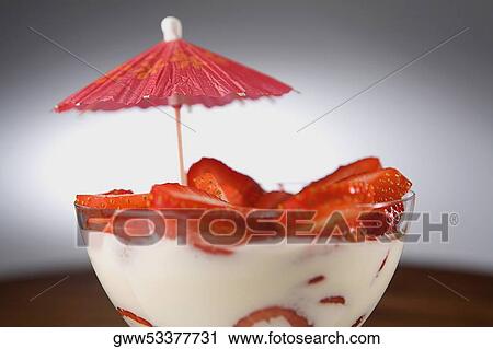Close-up of a drink umbrella with a bowl of strawberry milkshake View Large Photo Image Stock Image - Close-up of a drink umbrella with a bowl of strawberry milkshake. Fotosearch