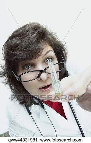 Close-up of a female doctor holding a vial View Large Photo Image Stock Image - Close-up of a female doctor holding a vial. Fotosearch