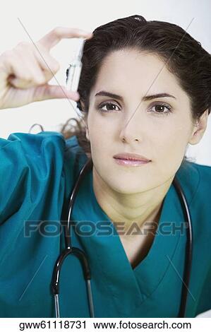 Close-up of a female doctor holding a vial View Large Photo Image Stock Image - Close-up of a female doctor holding a vial. Fotosearch