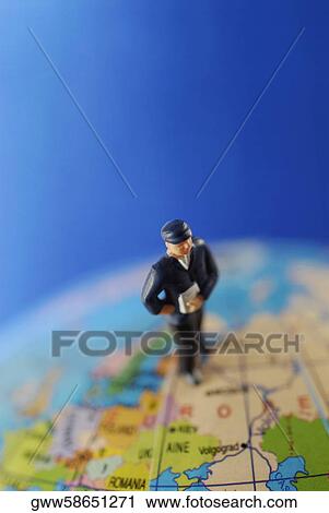 Close-up of a figurine on a globe View Large Photo Image Stock Image - Close-up of a figurine on a globe. Fotosearch