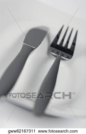 Close-up of a fork and a spoon in a plate View Large Photo Image Stock Image - Close-up of a fork and a spoon in a plate. Fotosearch