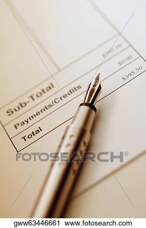 Stock Image - Close-up of a fountain pen on a bill. Fotosearch