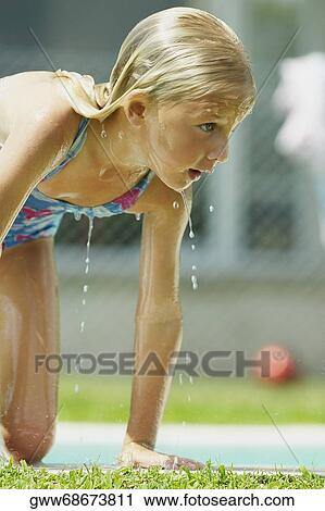 Close-up of a girl getting out of a swimming pool View Large Photo Image Stock Image - Close-up of a girl getting out of a swimming pool. Fotosearch