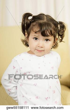 Close-up of a girl standing in front of a couch View Large Photo Image Stock Image - Close-up of a girl standing in front of a couch. Fotosearch