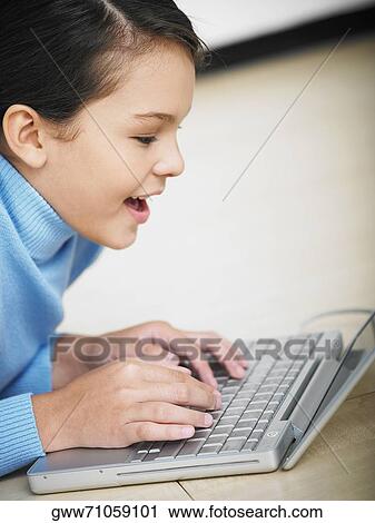 Stock Image - Close-up of a girl using a laptop. Fotosearch