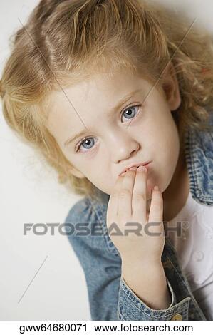 Close-up of a girl with her finger on her lips View Large Photo Image Stock Image - Close-up of a girl with her finger on her lips. Fotosearch