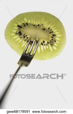 Close-up of a kiwi fruit with a fork View Large Photo Image Stock Image - Close-up of a kiwi fruit with a fork. Fotosearch