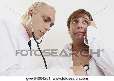 Close-up of a male doctor examining a patient with a stethoscope View Large Photo Image Stock Image - Close-up of a male doctor examining a patient with a stethoscope. Fotosearch