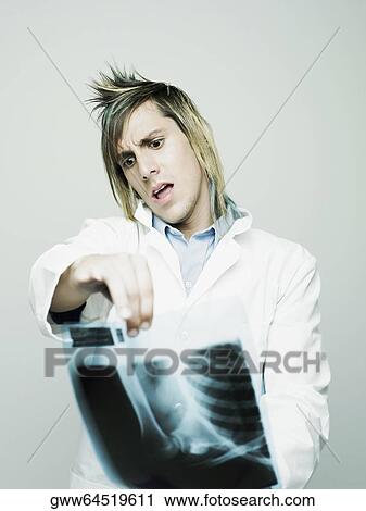 Close-up of a male doctor examining an X-Ray View Large Photo Image Stock Image - Close-up of a male doctor examining an X-Ray. Fotosearch