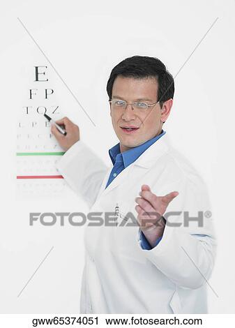 Close-up of a male doctor pointing towards an eye chart View Large Photo Image Stock Image - Close-up of a male doctor pointing towards an eye chart. Fotosearch
