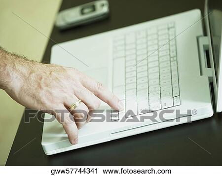 Close-up of a man's finger on a laptop View Large Photo Image Stock Image - Close-up of a man's finger on a laptop. Fotosearch
