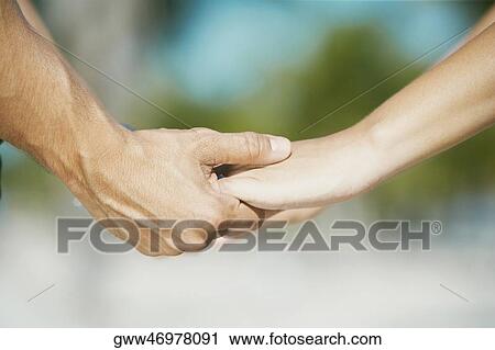 Close-up of a man's hand holding a woman's hand View Large Photo Image Stock Image - Close-up of a man's hand holding a woman's hand. Fotosearch
