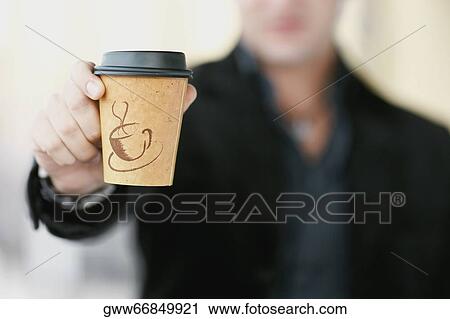 Close-up of a man's hand showing a coffee cup View Large Photo Image Stock Image - Close-up of a man's hand showing a coffee cup. Fotosearch