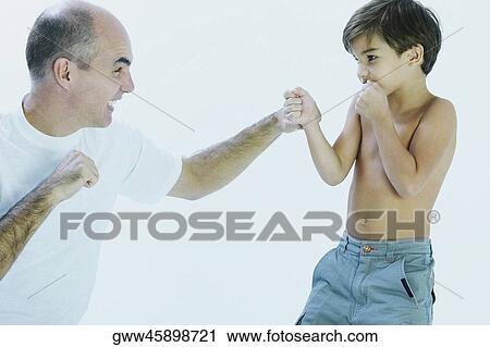 Close-up of a mature man and his son fighting View Large Photo Image Stock Image - Close-up of a mature man and his son fighting. Fotosearch