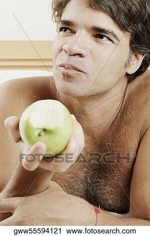Close-up of a mature man eating an apple View Large Photo Image Stock Image - Close-up of a mature man eating an apple. Fotosearch