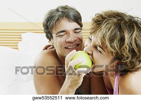 Close-up of a mature man feeding an apple to a mature woman View Large Photo Image Stock Image - Close-up of a mature man feeding an apple to a mature woman. Fotosearch