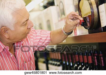 Close-up of a mature man pressing the faucet on a keg View Large Photo Image Stock Image - Close-up of a mature man pressing the faucet on a keg. Fotosearch