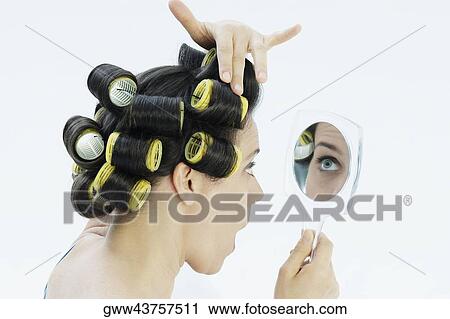 Close-up of a mature woman adjusting her hair curlers View Large Photo Image Stock Image - Close-up of a mature woman adjusting her hair curlers. Fotosearch