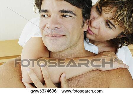 Close-up of a mature woman embracing a mature man from behind View Large Photo Image Stock Image - Close-up of a mature woman embracing a mature man from behind. Fotosearch