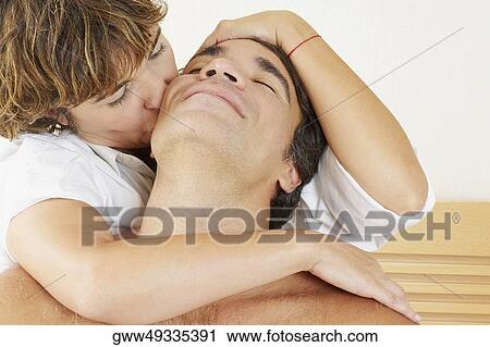 Stock Image - Close-up of a mature woman kissing a mature man. Fotosearch