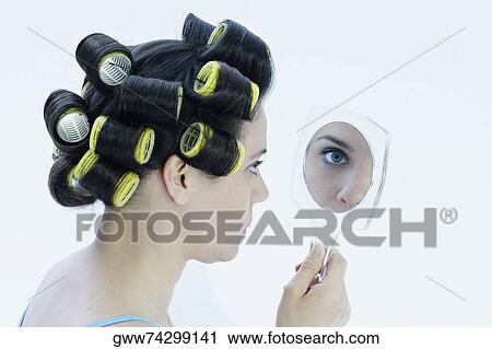 Close-up of a mature woman looking in a hand mirror View Large Photo Image Stock Image - Close-up of a mature woman looking in a hand mirror. Fotosearch