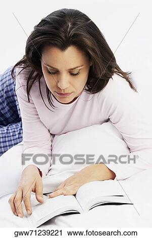 Close-up of a mature woman reading a book View Large Photo Image Stock Image - Close-up of a mature woman reading a book. Fotosearch