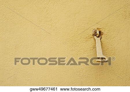 Stock Image - Close-up of a metal hook on a wall. Fotosearch