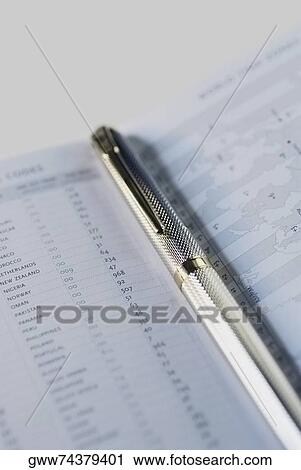 Close-up of a metal pen on a diary View Large Photo Image Stock Image - Close-up of a metal pen on a diary. Fotosearch