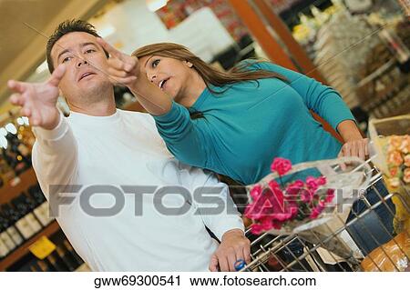Close-up of a mid adult man and a young woman in a supermarket View Large Photo Image Stock Image - Close-up of a mid adult man and a young woman in a supermarket. Fotosearch